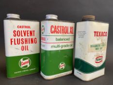 A Castrol Solvent Flushing Oil quart can, a second for Castrol XL and a third for Texaco.