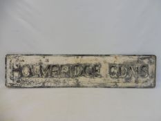 A street name sign for Holmbridge Gadns, 50 x 11".