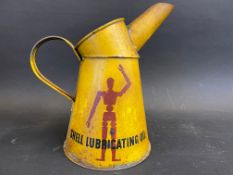 A Shell Lubricating Oil robot/stick man quart measure.