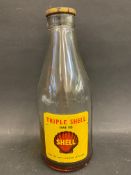 A Shell 'Triple Shell' SAE 50 glass bottle with a good label and an original cap.