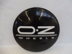 A circular plastic advertising sign for O.Z. Wheels, 25" diameter.
