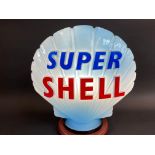 A blue Super Shell glass petrol pump globe by Hailware, fully stamped underneath 'Property of