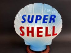A blue Super Shell glass petrol pump globe by Hailware, fully stamped underneath 'Property of