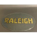 A Raleigh oval glass garage showrrom bevel edged glass hanging sign, 13 3/4 x 9 1/2".