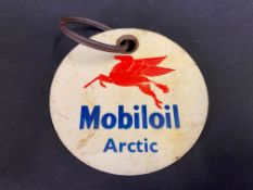 A Mobiloil Arctic grade celluloid circular brand indicator, 3" diameter.