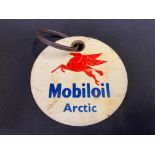 A Mobiloil Arctic grade celluloid circular brand indicator, 3" diameter.
