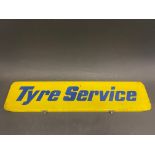 A rectangular tin pediment sign for 'Tyre Service', 24 x 5 1/2".