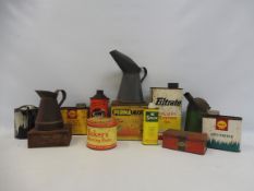 A quantity of assorted oil cans and measures.