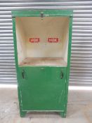 A green painted oil cabinet, lacking oil pumps, would convert to alternative storage uses.