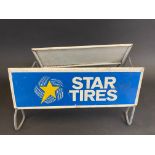 A Star Tires tyre display stand with advertising sign to both sides.
