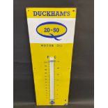 A Duckham's 20-50 Motor Oil enamel thermometer in very good condition, complete with working tube,