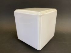 A square milk glass globe of small size, unlettered.