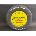 A quirky Dunlop Radial Tyres perspex advertising clock set within a full size car tyre, 22 1/2"