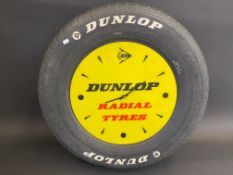 A quirky Dunlop Radial Tyres perspex advertising clock set within a full size car tyre, 22 1/2"