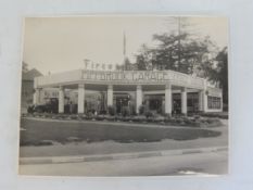 A black and white photograph of a very stylish Pippbrook Garage Service Station, with a row of