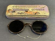 A cased pair of 'Competition Goggles', with an image of six means of transport to the lid.