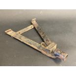 A two gallon wing or running board mounting bracket made by Pennant.