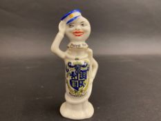 A rare crested ware porcelain figure of a petrol pump attendant in the shape of a petrol pump