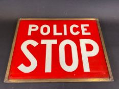 A 'Police Stop' red and white glass road sign in a brass frame, 12 1/2 x 9 3/4".