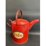 A garage filling station watering can, bearing Esso decals.