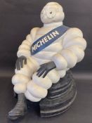A large scale seated Mr. Bibendum sat on a stylised stack of tyres, 20" tall.