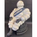 A large scale seated Mr. Bibendum sat on a stylised stack of tyres, 20" tall.