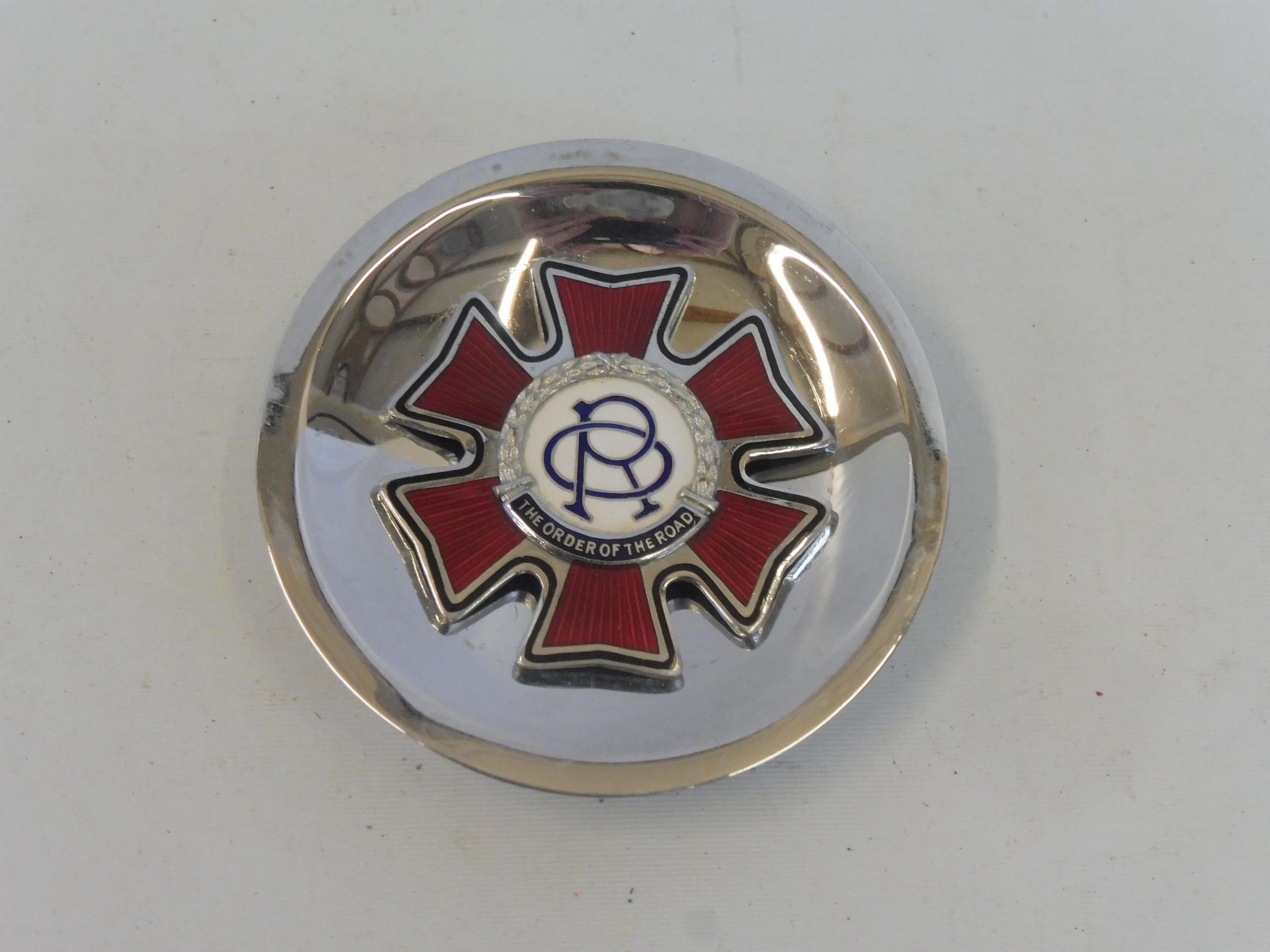 An Order of the Road Series 1, type 5 badge, with mounting bolt in the centre of the back,