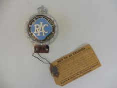 An RAC 1953 prototype car badge, with large lozenge enamel centre, still retaining a cardboard tag