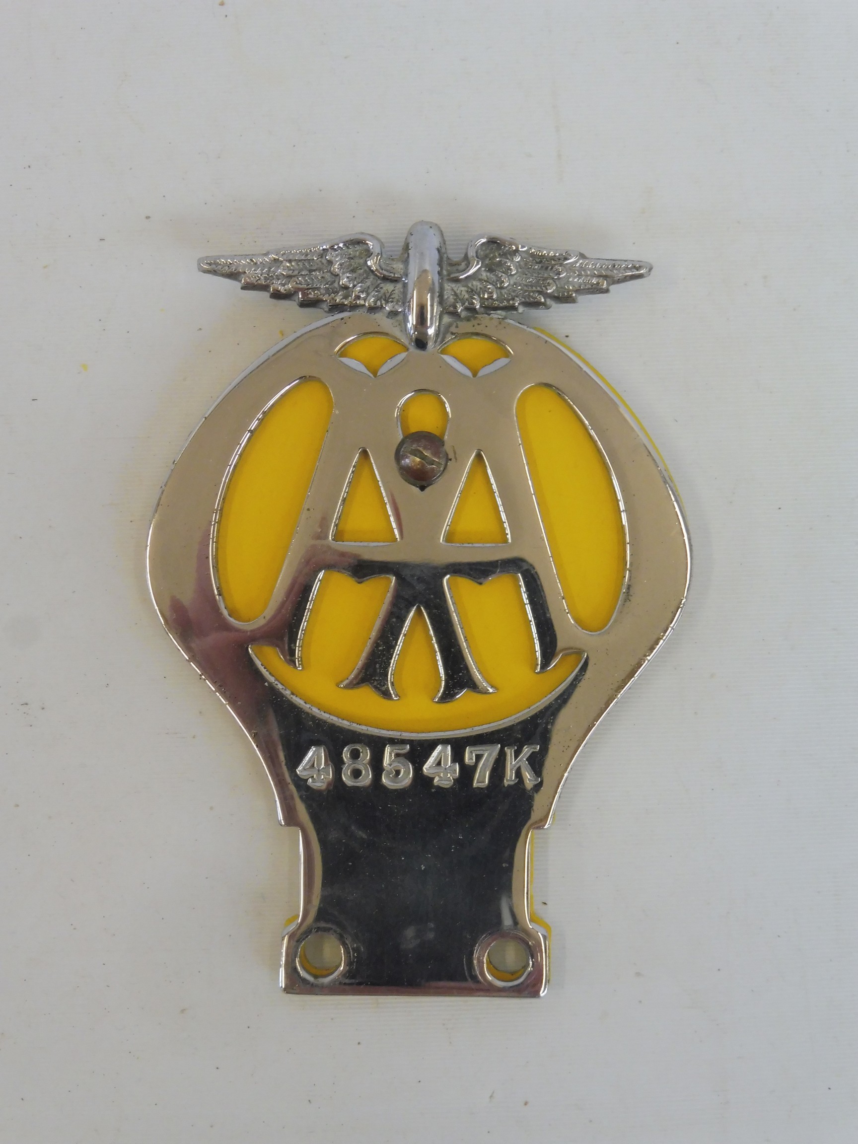 An early yellow back AA motorcycle badge with centre screw, stamped 485-47K circa 1938.