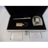 A Rolls-Royce gift box set containing a desk clock, pen and keyring.
