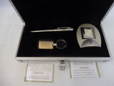 A Rolls-Royce gift box set containing a desk clock, pen and keyring.