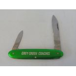 A promotional penknife advertising 'Grey-Green Coaches'.