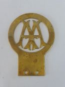 An AA Stenson Cooke type brass badge celebrating the lengthy run of the badge.