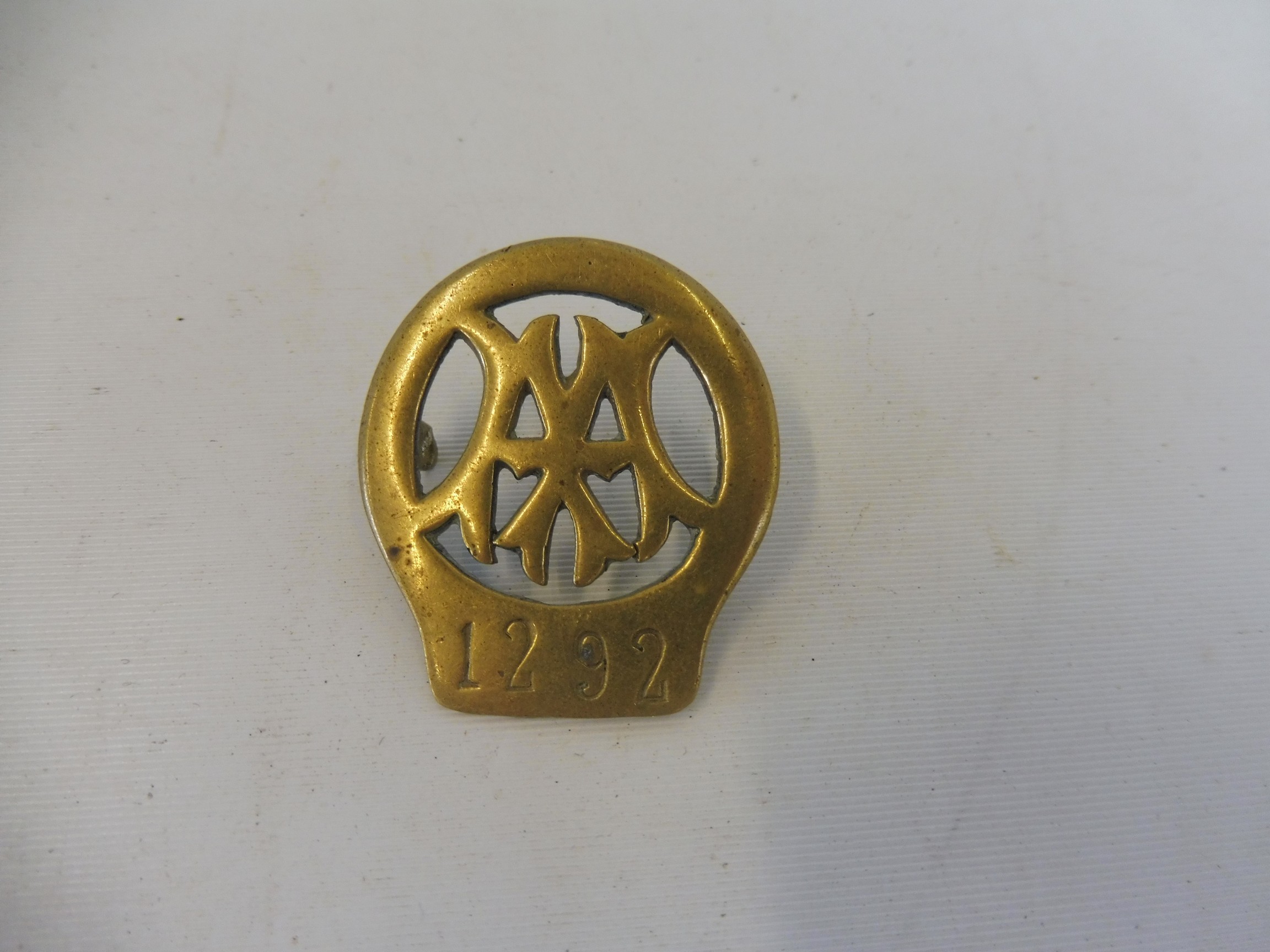 An early AA cap badge, bearing the number 1292.