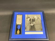 A framed and glazed RAC medal for 35 years service presented to Miss Winifred Cross, who looked