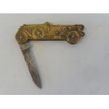 A miniature penknife in the shape of an Edwardian motor car.