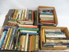 Four large boxes of assorted motoring related volumes.