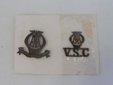 An AA Voluntary Service Corps badge plus a second V.S.C. badge.