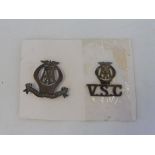 An AA Voluntary Service Corps badge plus a second V.S.C. badge.