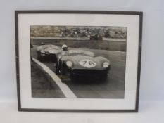 A framed and glazed black and white photograph of Graham Whitehead in an Aston Martin DB35 and