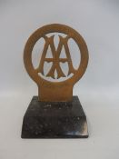 An AA Stenson Cooke style brass badge engraved 'Service Delivery Awards' 1906-1911, display base
