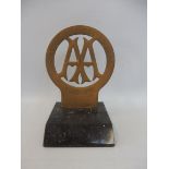 An AA Stenson Cooke style brass badge engraved 'Service Delivery Awards' 1906-1911, display base