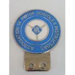 An RAC Association of Motor Schools & Instructors car badge.