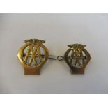 Two different sized AA brass cap badges.