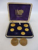 A cased set of Bentley buttons, one small one missing plus two Pratts brass buttons.