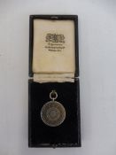 A Royal Automobile Club silver plated medallion awarded to E.J. Baker, holder of the RAC Driving