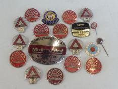 Approximately 20 bus badges.