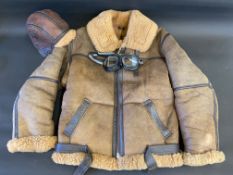 An Irvin flying jacket size 40 in very good condition with matching hat and goggles.