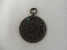 A Royal Automobile Club circular pendant, awarded to Clarance Plummer, holder of the R.A.C.