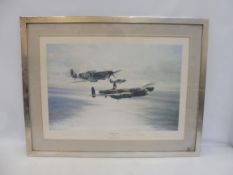 A framed and glazed Robert Taylor print depicting the Spitfire, Hurricane and Lancaster titled '